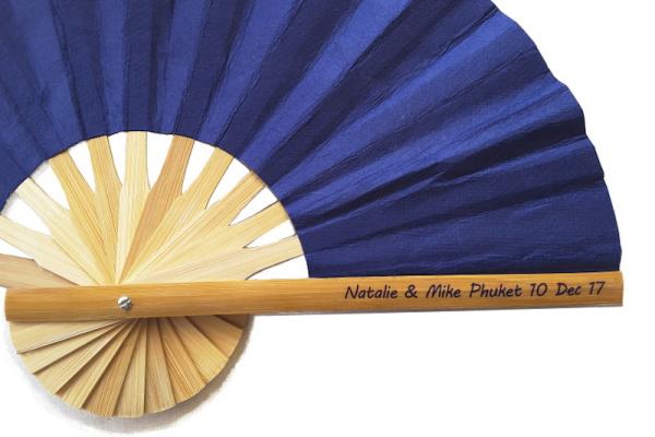 Clear sticker showing wedding names, place and date on the handle of a bamboo wedding fan