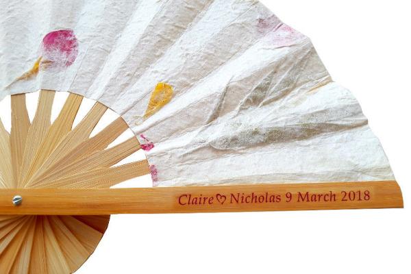 Wedding fan personalized with clear sticker names and date.